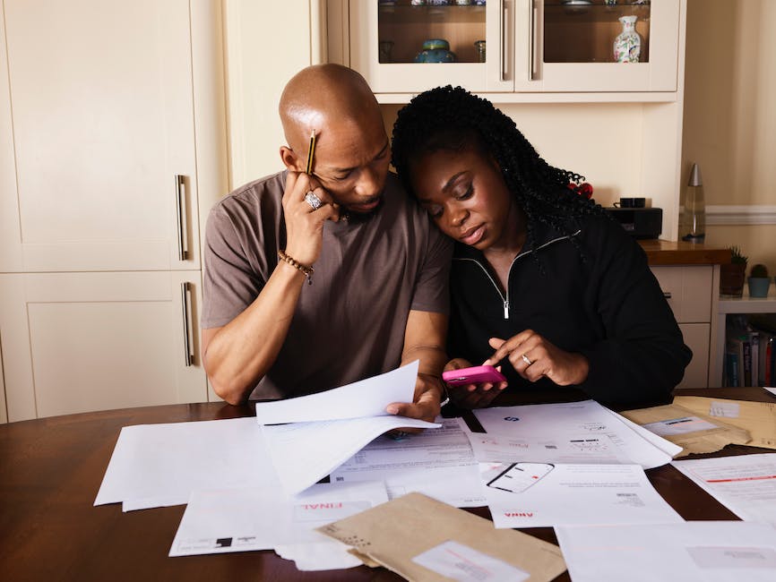 Image depicting a student calculating expenses for college